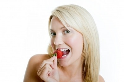woman eating strawberry